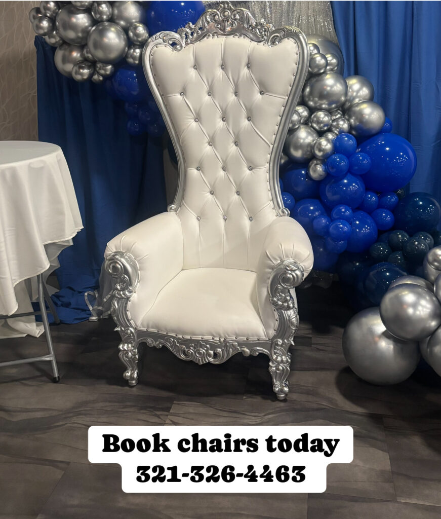 Silver and white throne chair with blue balloon event backdrop